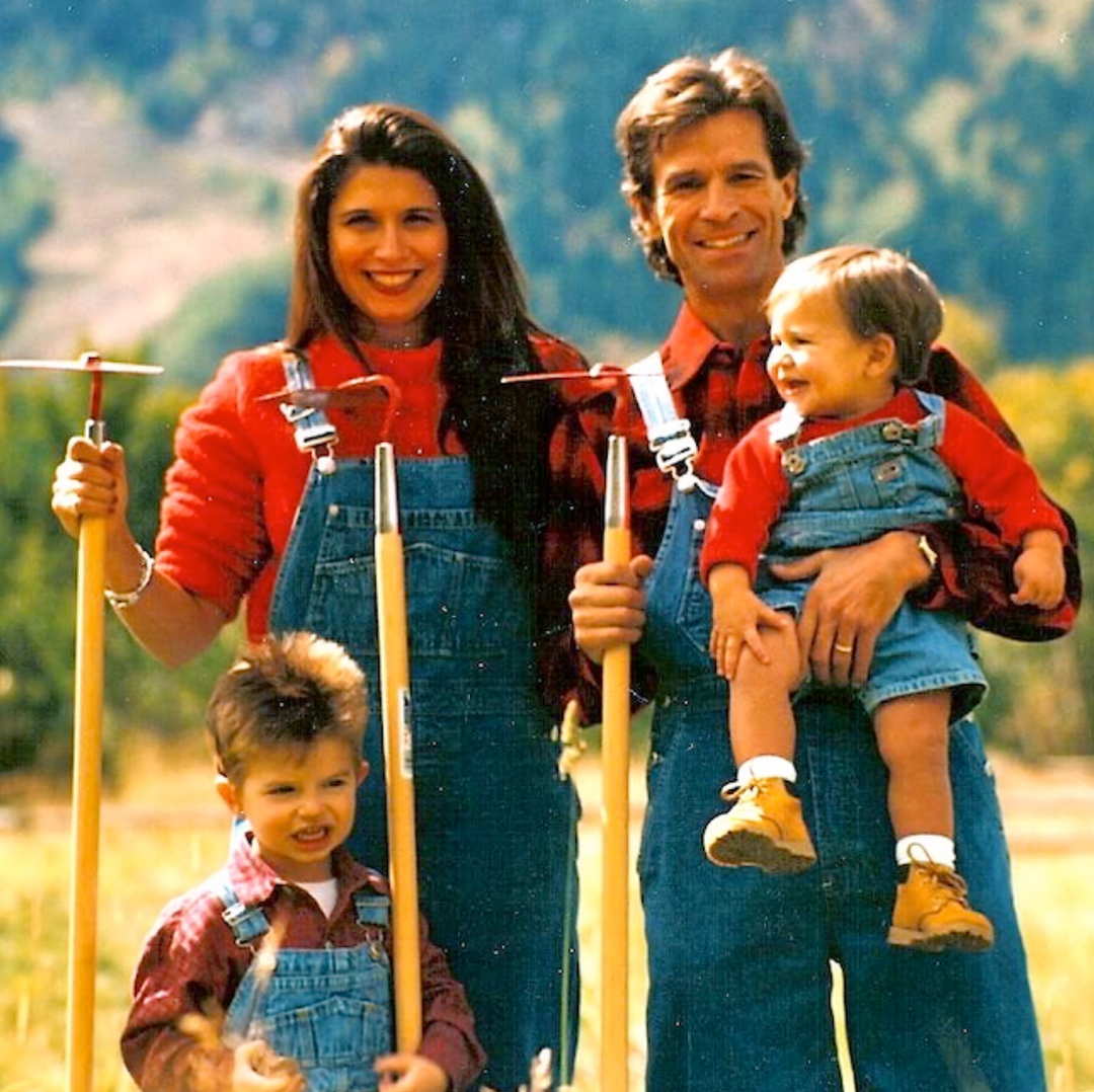 Mother and father with two kids on a farm